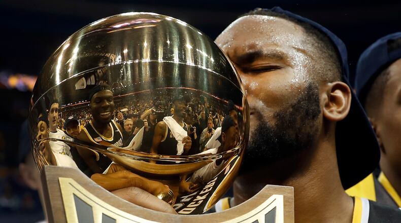 Wichita State’s Shaquille Morris kisses the trophy after the Shockers defeated Illinois State 71-51 to win the championship of the Missouri Valley Conference on Sunday, March 5, 2017, in St. Louis. (AP Photo/Jeff Roberson)