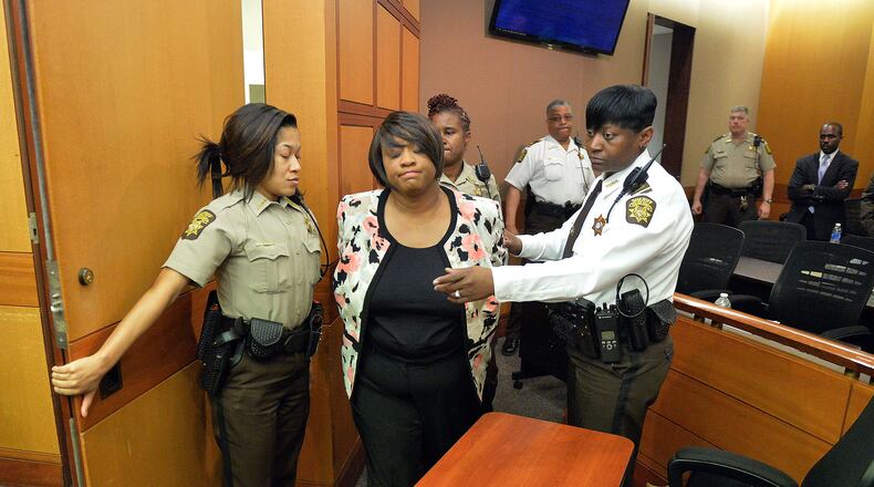 Former Atlanta Public Schools School Reform Team Director Tamara Cotman is led to a holding cell after a jury convicted her of a racketeering charge on April 1, 2015. Public-records requests uncovered information showing educators engaged in a conspiracy to inflate test scores. (AJC FILE PHOTO)
