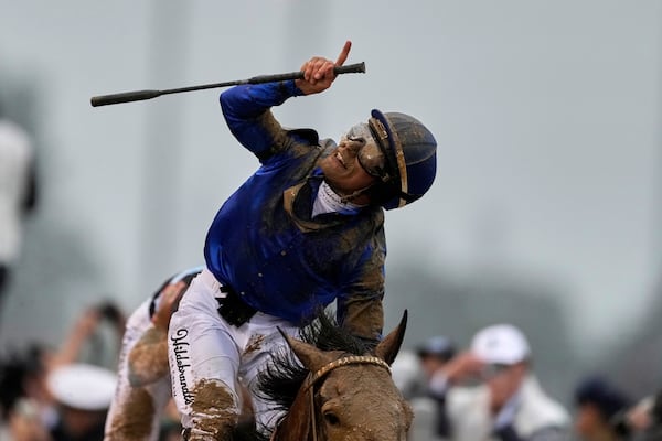 Jockey Junior Alvarado celebrates after riding Sovereignty to victory in the 151st running of the Kentucky Derby horse race at Churchill Downs Saturday, May 3, 2025, in Louisville, Ky. (AP Photo/Brynn Anderson)