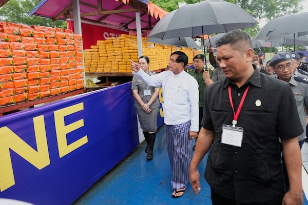 Yangon region Chief Minister Soe Thein, second left in white cloth, inspects seized illegal narcotics during a destruction ceremony to mark International Day against Drug Abuse and Illicit Trafficking, on the outskirts of Yangon, Myanmar, Thursday, June 26, 2025. (AP Photo/Thein Zaw)