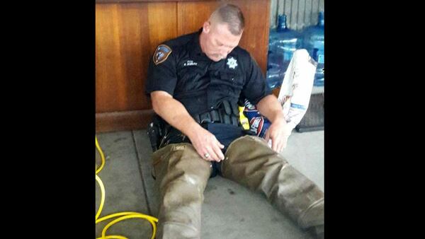 Harris County, Texas, Deputy Robert Goerlitz slumps against a desk in exhaustion Aug. 27, 2017, after working for more than 20 hours to rescue people from floodwaters in the aftermath of Hurricane Harvey, which devastated Houston and the surrounding area.