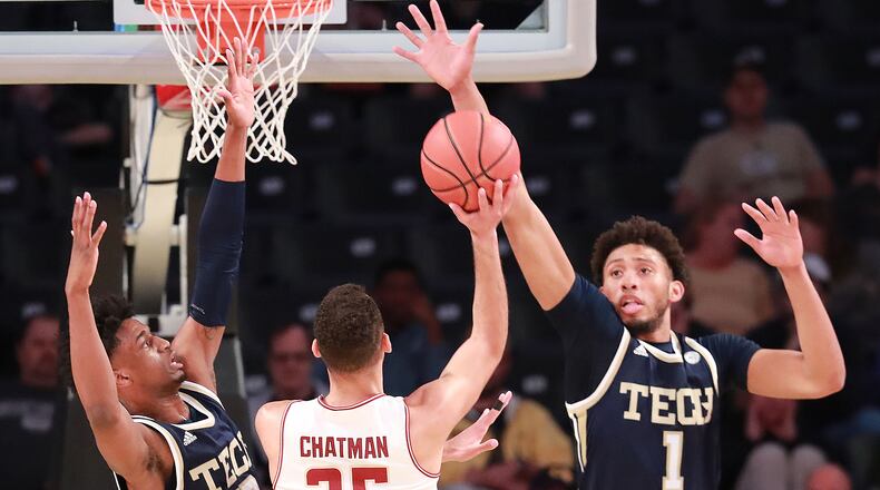Georgia Tech defenders Khalid Moore (left) and James Banks III block a shot by Boston College guard Jordan Chatman in a NCAA college basketball game on Sunday, March 3, 2019, in Atlanta. Curtis Compton/ccompton@ajc.com