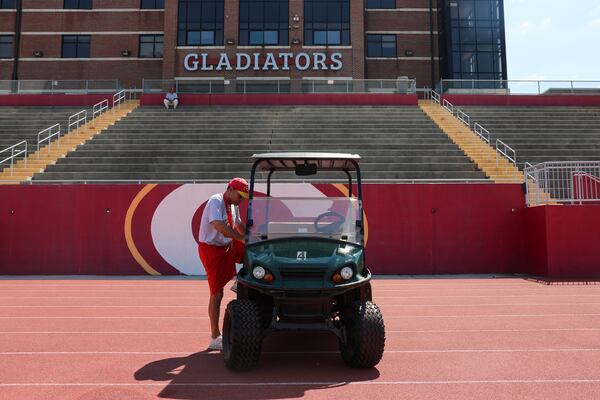 Clarke Central baseball and football coach David Perno gets into a golf cart during football practice at Clarke Central in Athens on Tuesday, July 7, 2026. Now battling cancer, Perno uses the golf cart to get around more than he used to. (Arvin Temkar/AJC)