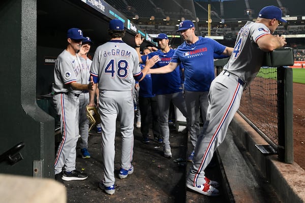Texas Rangers starting pitcher Jacob deGrom (48) reacts with teammates after he was pulled during the eighth inning of a baseball game against the Baltimore Orioles, Wednesday, June 25, 2025, in Baltimore. (AP Photo/Nick Wass)