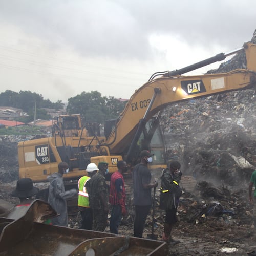 Rescue workers search through a heap of refuse after it collapsed at Conakry’s largest landfill, Guinea, Sunday, Aug. 23, 2026. (AP Photo/Fodo Toure)