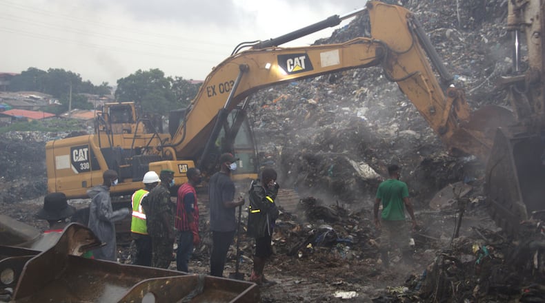 Rescue workers search through a heap of refuse after it collapsed at Conakry’s largest landfill, Guinea, Sunday, Aug. 23, 2026. (AP Photo/Fodo Toure)