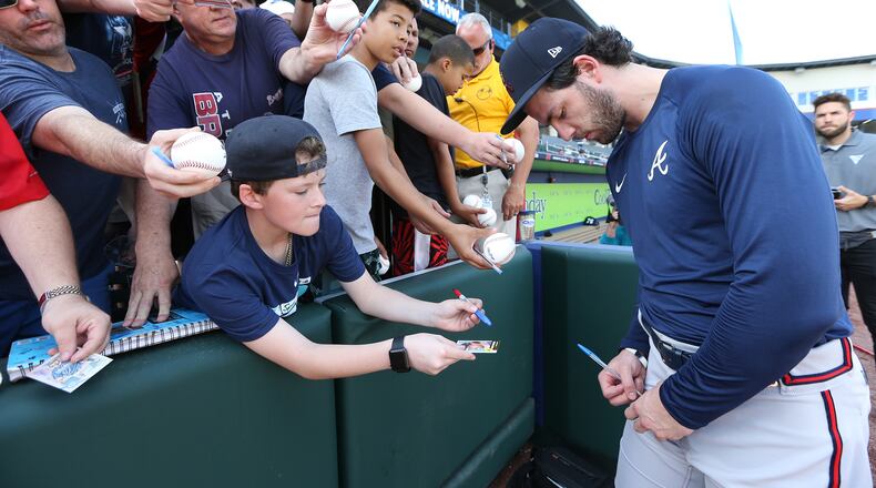 Dansby Swanson signs autographs at CoolToday Park last month.