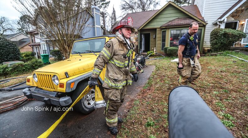 DeKalb County crews responding to a condo fire on Park Gate Place outside the city of Stone Mountain on Friday morning learned a woman was trapped inside.