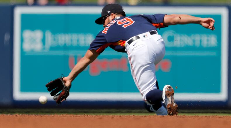 Houston Astros shortstop Jack Mayfield dives for a ground ball single by New York Mets' Michael Conforto during the third inning of a spring training baseball game Saturday, Feb. 29, 2020, in West Palm Beach, Fla. (Jeff Roberson/AP)