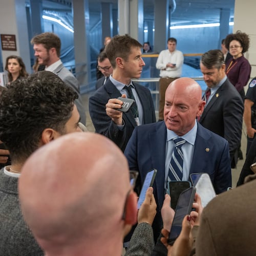 Sen. Mark Kelly, D-Ariz, speaks to reporters near the Senate Subway stakeout, Thursday, Dec. 4, 2025 in Washington. (AP Photo/Kevin Wolf)