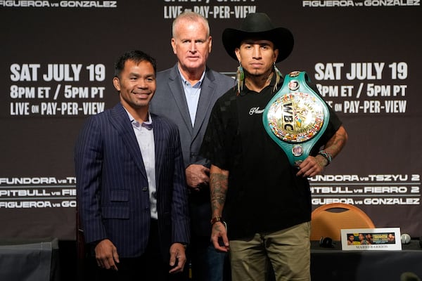 Manny Pacquiao, left, and WBC welterweight champion Mario Barrios pose at a news conference Wednesday, July 16, 2025, in Las Vegas. (AP Photo/John Locher)