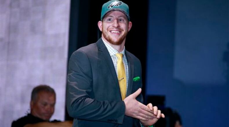 North Dakota State�s Carson Wentz walks on the stage after being selected by Philadelphia Eagles as second pick in the first round of the 2016 NFL football draft, Thursday, April 28, 2016, in Chicago. (Jeff Haynes/AP Images for Panini)