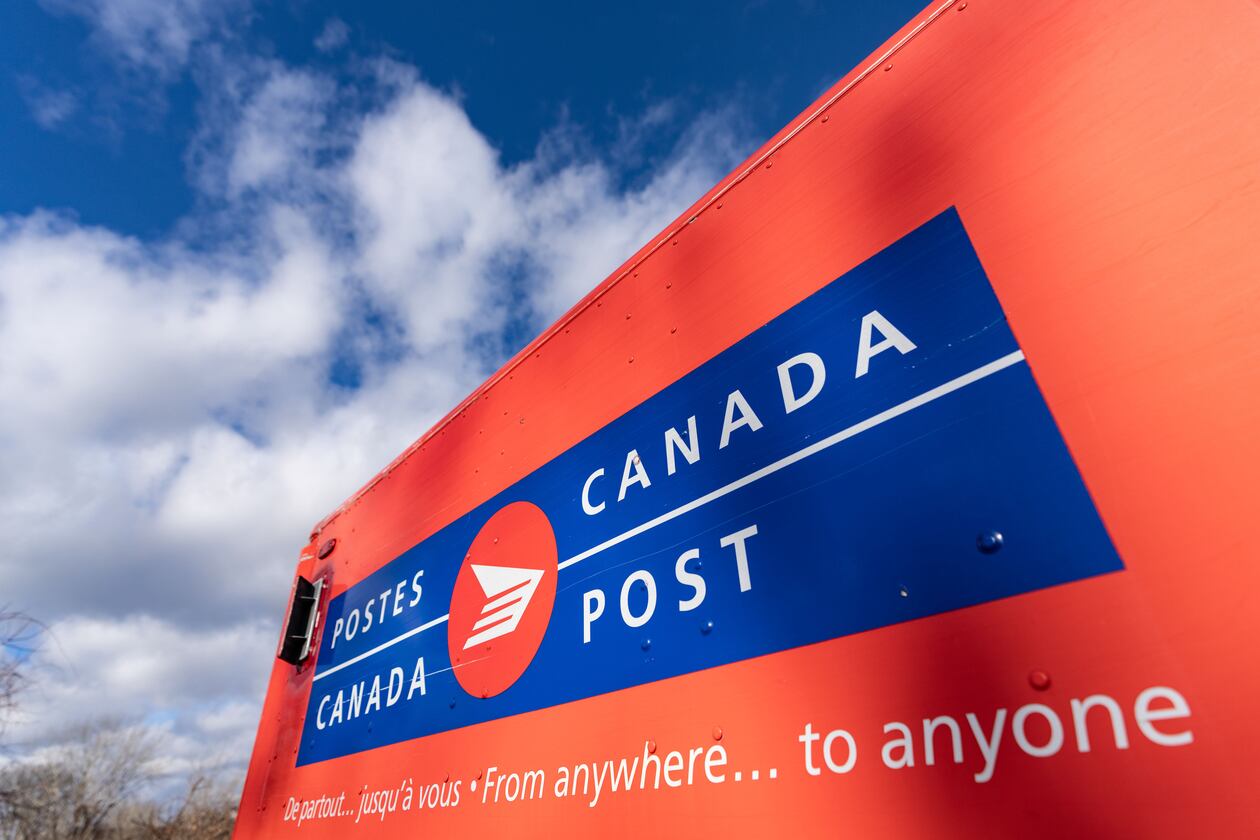 FILE - A Canada Post mail truck is seen parked in their distribution center, in Montreal, Nov. 27, 2024. (Christinne Muschi/The Canadian Press via AP, File)