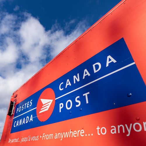 FILE - A Canada Post mail truck is seen parked in their distribution center, in Montreal, Nov. 27, 2024. (Christinne Muschi/The Canadian Press via AP, File)