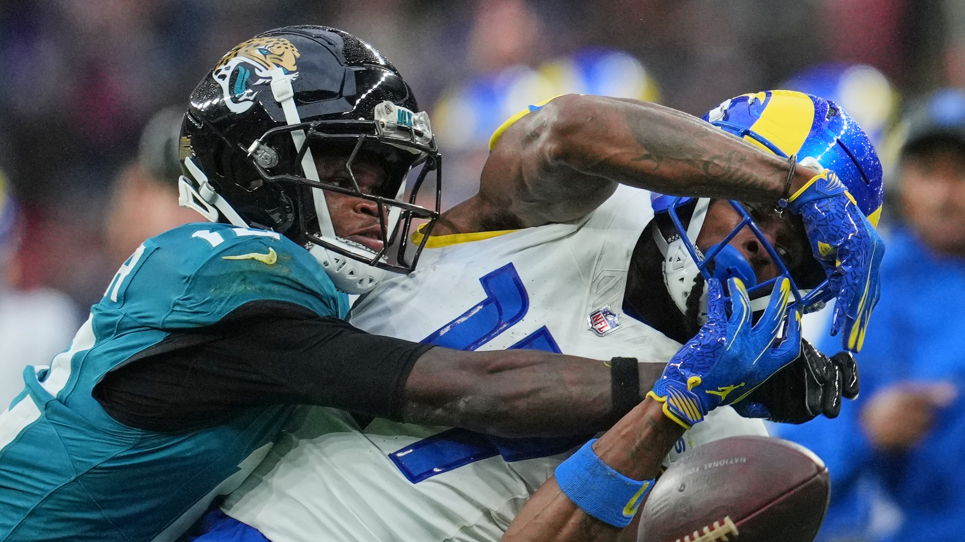 Los Angeles Rams wide receiver Davante Adams (17) is challenged by Jacksonville Jaguars wide receiver Travis Hunter (12) during the second half of an NFL football game between the Los Angeles Rams and the Jacksonville Jaguars in London, Sunday, Oct. 19, 2025. (AP Photo/Kin Cheung)