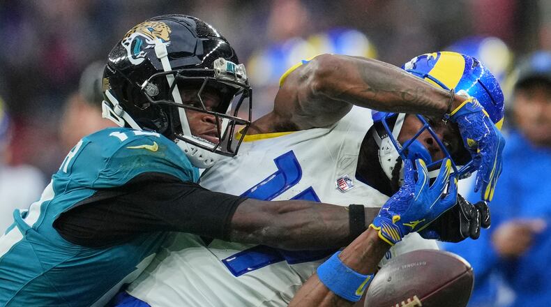 Los Angeles Rams wide receiver Davante Adams (17) is challenged by Jacksonville Jaguars wide receiver Travis Hunter (12) during the second half of an NFL football game between the Los Angeles Rams and the Jacksonville Jaguars in London, Sunday, Oct. 19, 2025. (AP Photo/Kin Cheung)