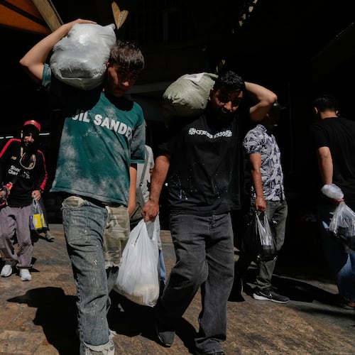 People carry packages at Tehran's historic Grand Bazaar, Iran, Monday, June 1, 2026. (AP Photo/Vahid Salemi)