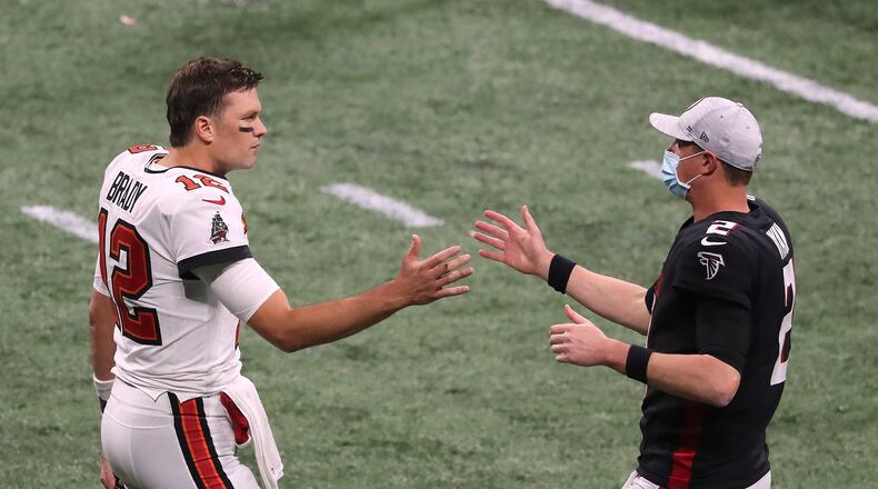 Tampa Bay Buccaneers quarterback Tom Brady and Atlanta Falcons quarterback Matt Ryan greet each other after the Buccaneers defeated the Falcons 31-27 on Sunday, Dec. 20, 2020, in Atlanta, Georgia. (Curtis Compton/Atlanta Journal-Constitution/TNS)