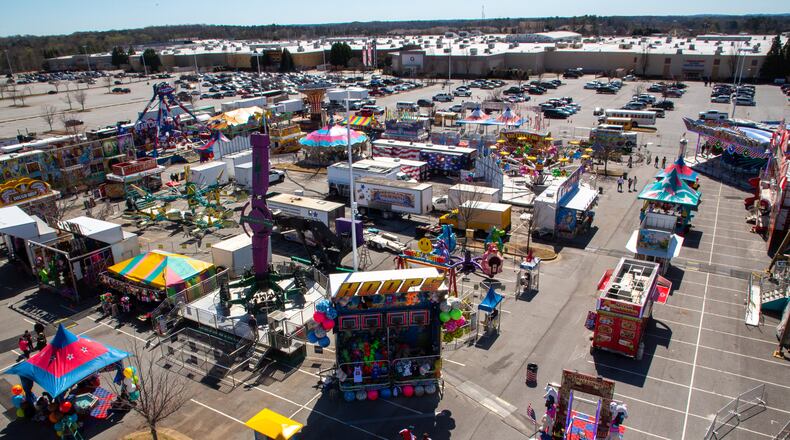 People walk around the Sugarloaf Mill Carnival in Lawrenceville Sunday, March 20, 2022. STEVE SCHAEFER FOR THE ATLANTA JOURNAL-CONSTITUTION