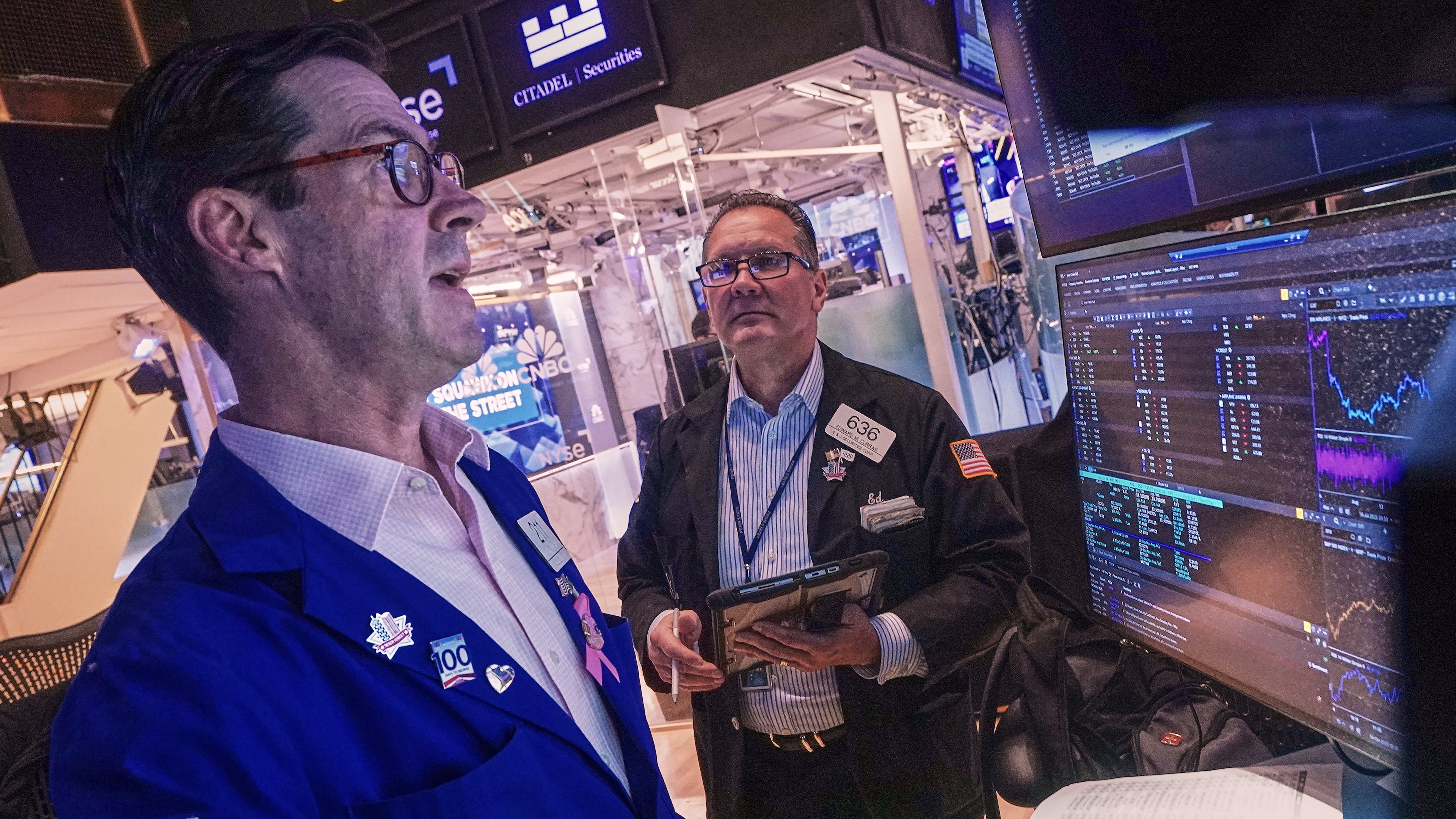 Specialist John McNierney, left, and trader Edward Curran work on the floor of the New York Stock Exchange, Wednesday, Oct. 15, 2025. (AP Photo/Richard Drew)