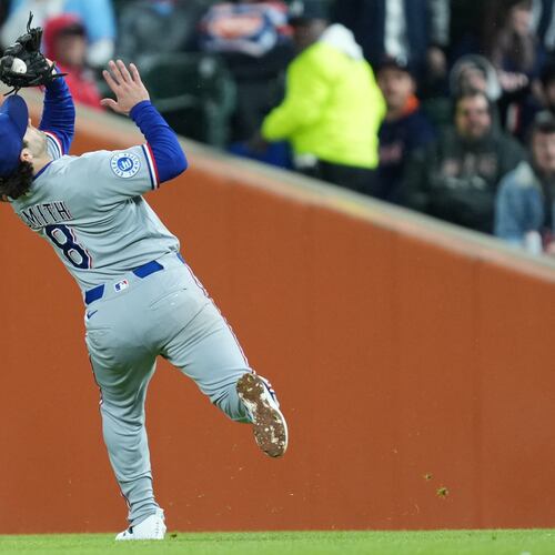 Texas Rangers second baseman Josh Smith (8) catches a Detroit Tigers' Matt Vierling fly ball during the fifth inning of a baseball game Friday, May 1, 2026, in Detroit. (AP Photo/Paul Sancya)