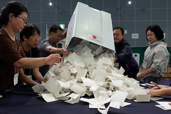 National Election Commission officials sort out ballots for counting at the presidential election in Seoul, South Korea, Tuesday, June 3, 2025. (AP Photo/Ahn Young-joon)