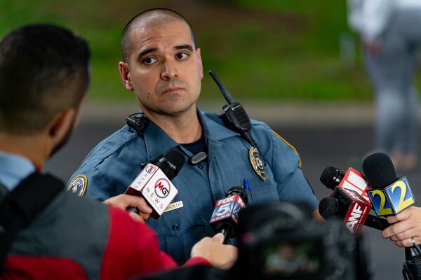 Gwinnett County police Cpl. Juan Madiedo speaks to reporters at the scene of an early morning shooting in front of a residence on Salem Drive. (Ben Hendren for the Atlanta Journal-Constitution)