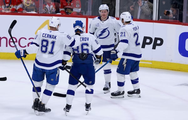 Tampa Bay Lightning center Jake Guentzel (59) celebrates with teammates after scoring against the Florida Panthers during the first period in Game 3 of an NHL hockey Stanley Cup first-round playoff series, Saturday, April 26, 2025, in Sunrise, Fla. (AP Photo/Rhona Wise)