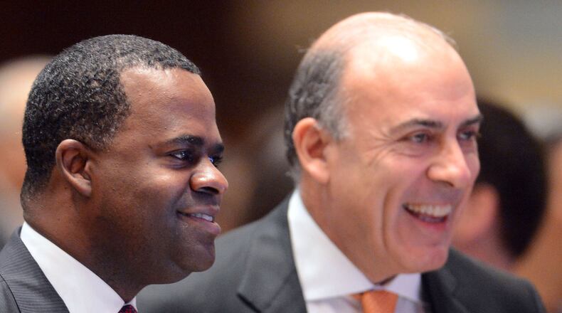 Mayor Kasim Reed (left) and Muhtar Kent greet attendees at the State of the City Speech in February. KENT D. JOHNSON / KDJOHNSON@AJC.COM