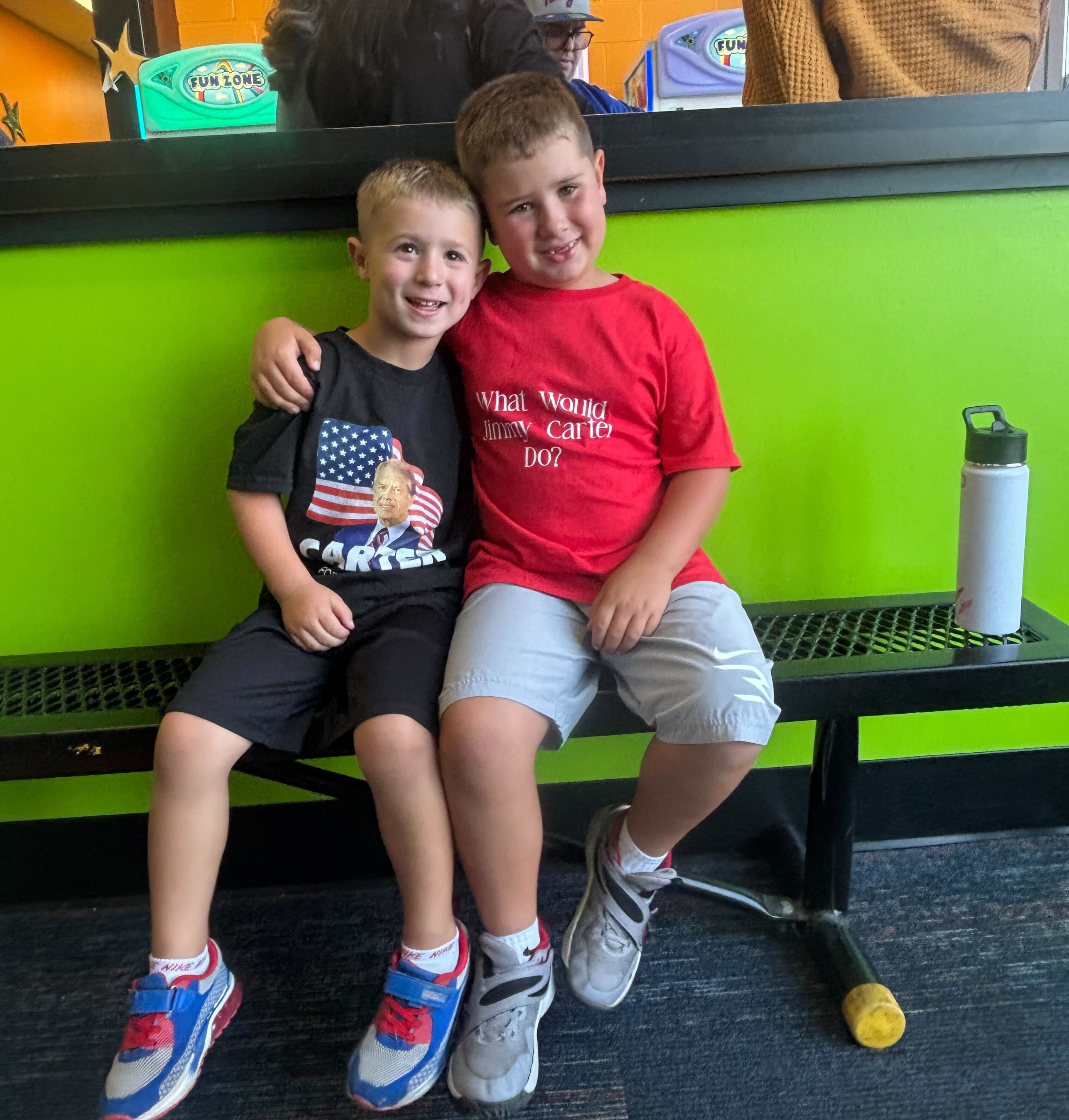 Ryan (left) and his brother, CJ, smile at Ryan's Jimmy Carter-themed birthday party, for which both boys wore Carter T-shirts. (Courtesy)