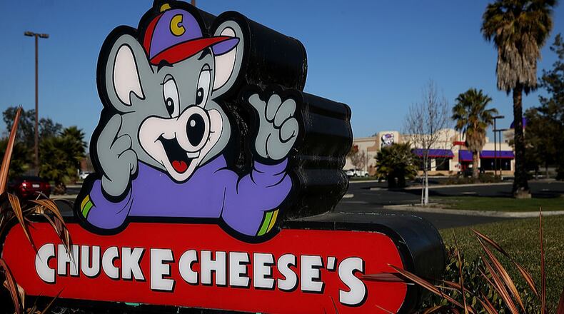 A sign in front of a Chuck E. Cheese restaurant. (Photo by Justin Sullivan/Getty Images)