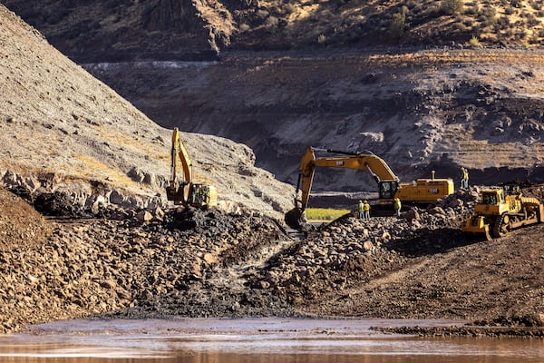 FILE - Construction crews remove the top of the cofferdam that was left of Iron Gate Dam allowing the Klamath River to run in its original path near Hornbrook, Calif., Aug. 28, 2024. (Carlos Avila Gonzalez/San Francisco Chronicle via AP, File)