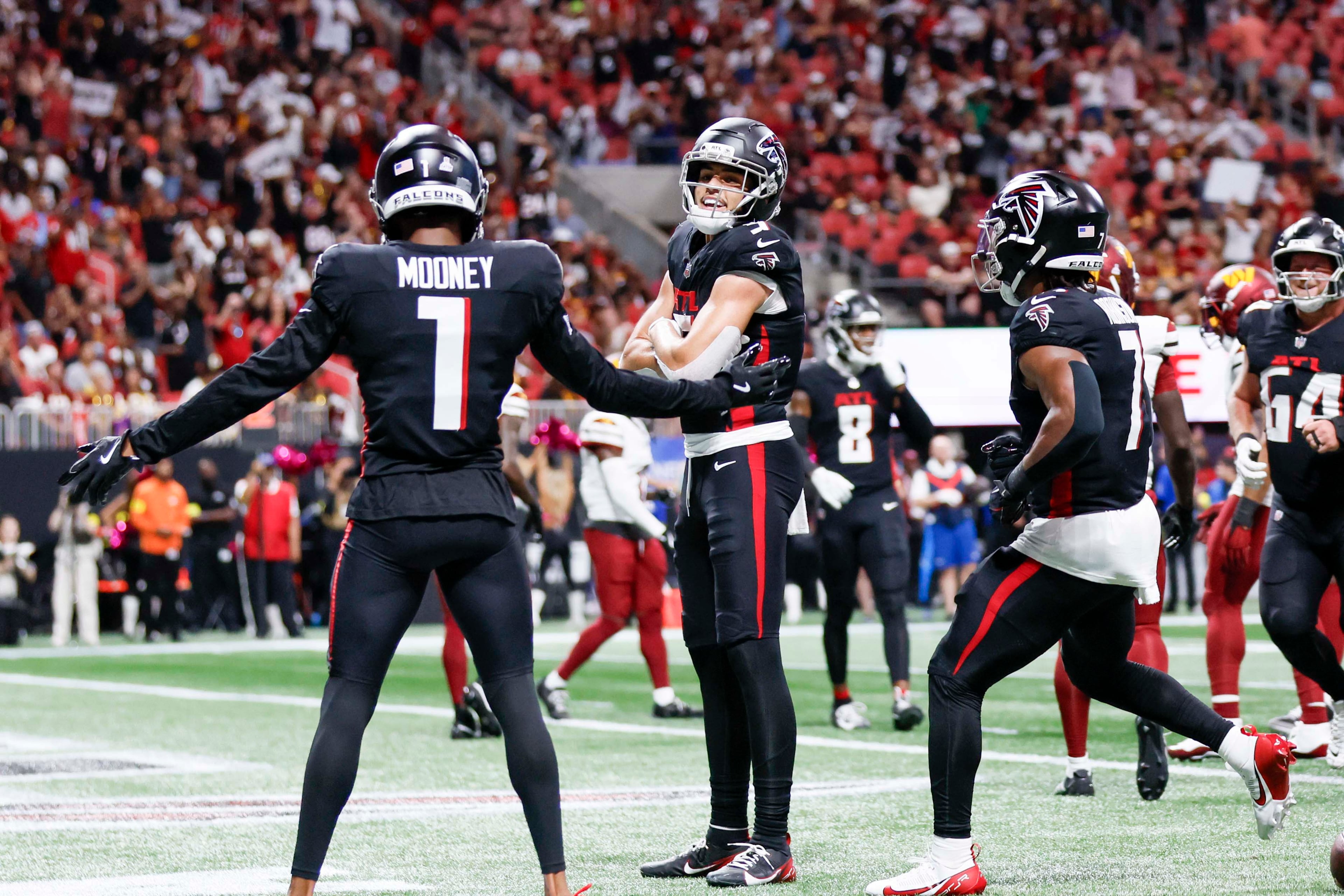 Atlanta Falcons wide receiver Drake London (middle) celebrates with teammates after scoring a touchdown during the first half of an NFL game against the Washington Commanders at Mercedes-Benz Stadium in Atlanta on Sunday, September 28, 2025. (Miguel Martinez/AJC)