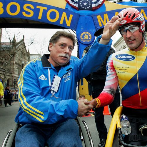 FILE - Ernst Van Dyk of South Africa, right, shakes hands with former wheelchair winner Bob Hall, after he won the mens wheelchair division of the 110th running of the Boston Marathon, Monday, April 17, 2006. (AP Photo/Elise Amendola, File)