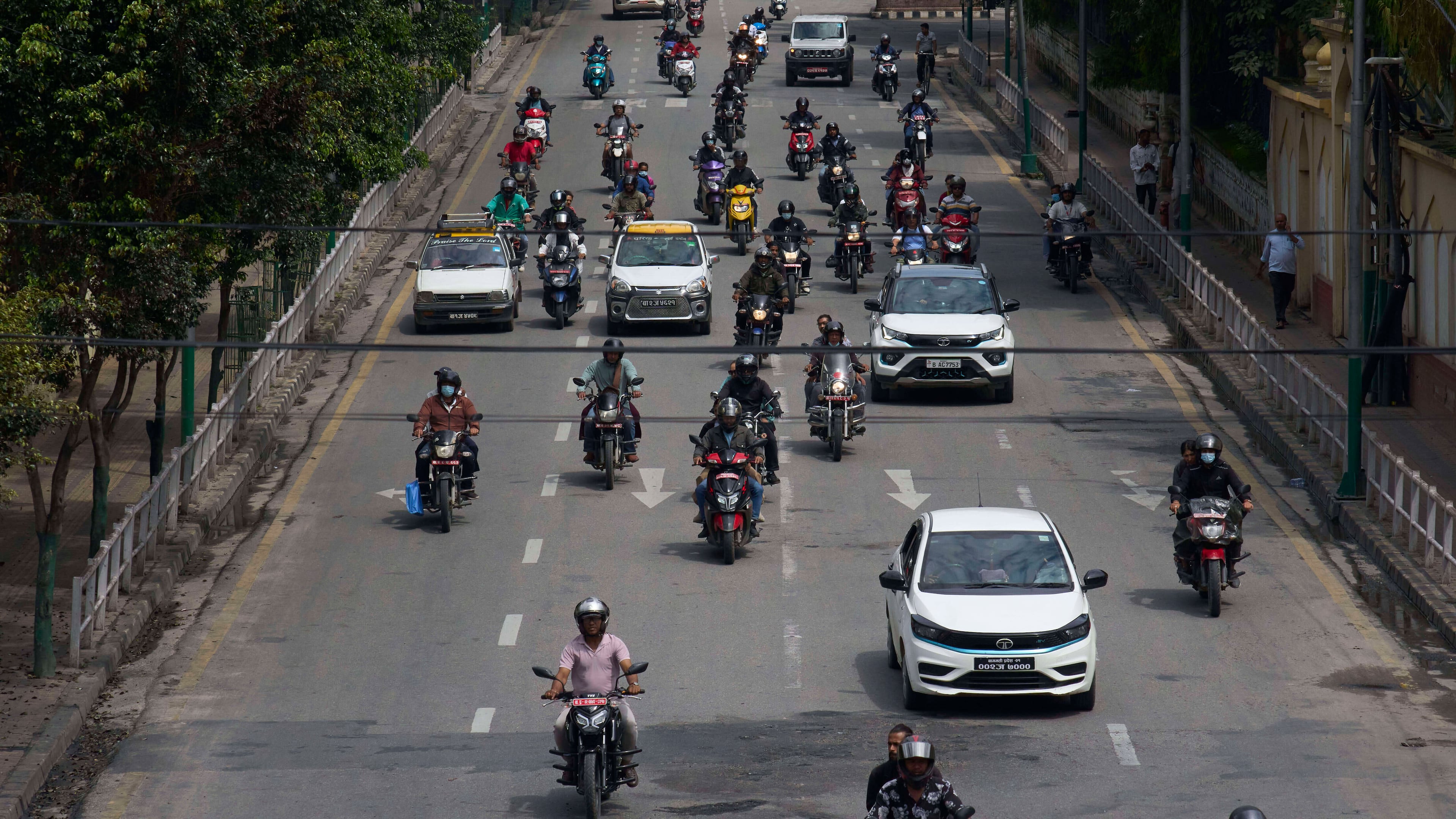 Vehicles move along the road after authorities lifted a days-long curfew imposed during anti-corruption protests sparked by a short-lived social media ban in Kathmandu, Nepal, Saturday, Sept. 13, 2025. (AP Photo/Niranjan Shrestha)