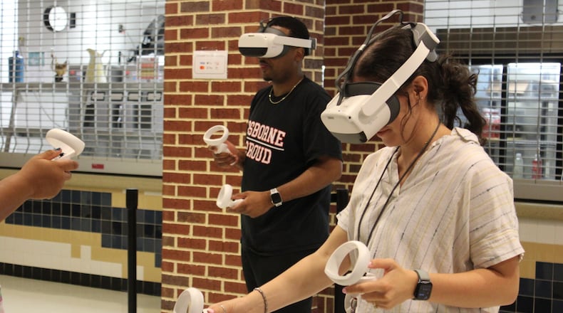 Roughly 400 of Cobb’s math and science teachers were trained to use Prisms VR headsets Monday at Wheeler High School.