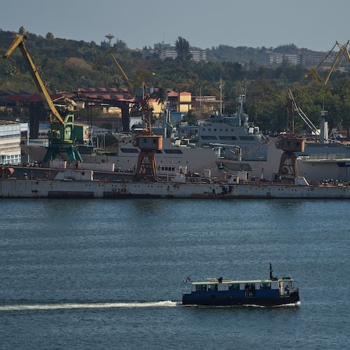 A ferry boat navigates across Havana Bay as it passes Cuban coast guard ships docked at the port as it leaves Casablanca, Cuba, Thursday, Feb. 26, 2026. (AP Photo/Ramon Espinosa)