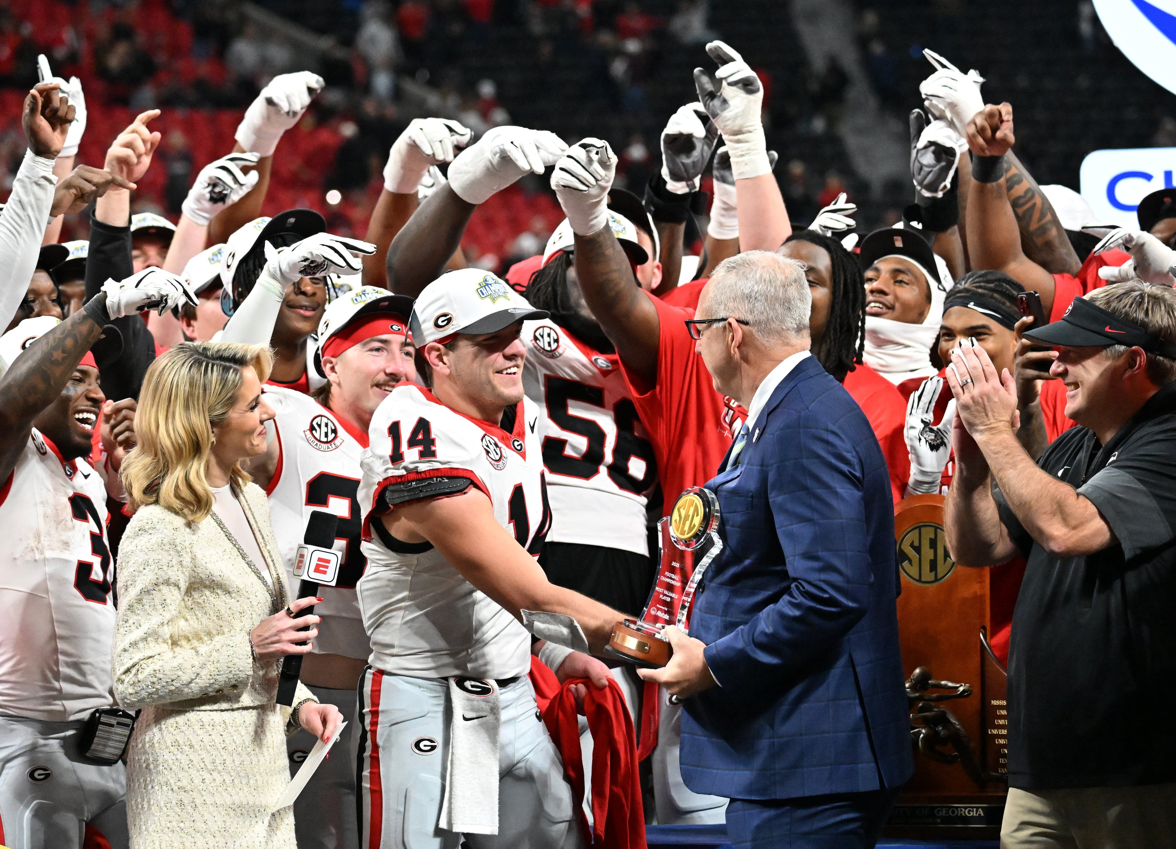 Georgia quarterback Gunner Stockton (14) receives his MVP trophy after defeating Alabama 28-7 in the SEC Championship football game at the Mercedes-Benz Stadium, Saturday, December 6, 2025 in Atlanta. (Hyosub Shin / AJC)