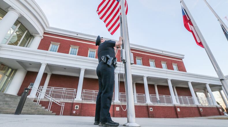 Flags were at half staff Monday morning at Clayton County police headquarters. JOHN SPINK / JSPINK@AJC.COM