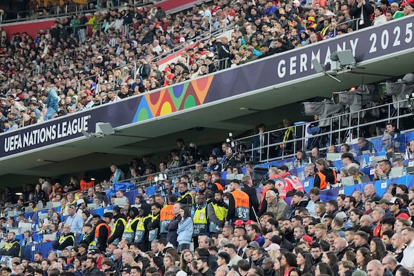Stewards secure the media tribune after a soccer fan died after falling from an overhead level onto a media area below during the Nations League Final soccer match between Spain and Portugal in Munich, Germany, Sunday, June 8, 2025. (AP Photo/Martin Meissner)