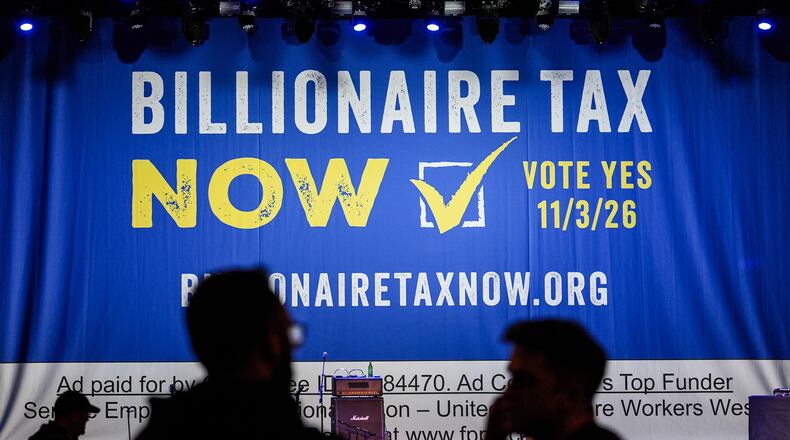 FILE - A large banner is seen at a campaign event for a proposed "billionaires tax" in Los Angeles on Feb. 18, 2026. (AP Photo/Jae C. Hong, File)