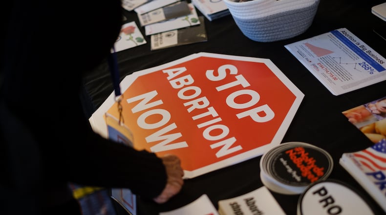 A person looks at materials at the National Right to Life booth at the National Right to Life Convention at the Airport Marriott Hotel in Atlanta on Friday, June 24, 2022. (Arvin Temkar / arvin.temkar@ajc.com)