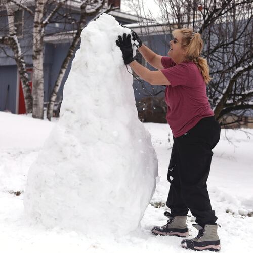 Bus driver Jackie Terry builds a snow sculpture for her students to enjoy along their bus route on Wednesday, Jan. 7, 2026 in Vergennes, Vt. (AP Photo/Amanda Swinhart)