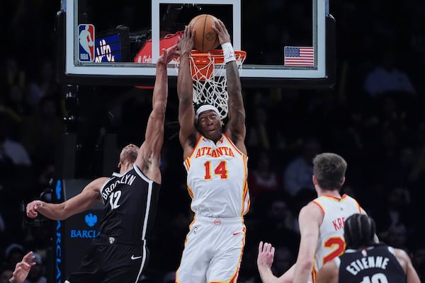 Brooklyn Nets' Tosan Evbuomwan (12) defends a shot by Atlanta Hawks' Terance Mann (14) during the second half of an NBA basketball game Thursday, April 10, 2025, in New York. (AP Photo/Frank Franklin II)