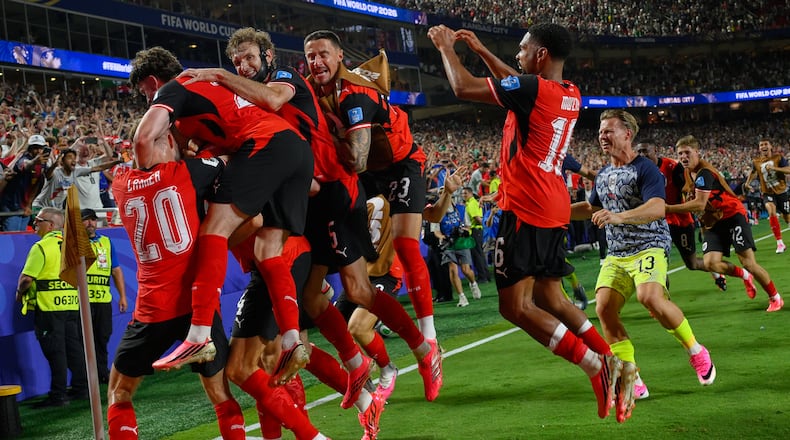 Austria's players celebrates after Austria's Sasa Kalajdzic (14) scored to tie the match during the World Cup Group J soccer match between Algeria and Austria in Kansas City, Mo., Saturday, June 27, 2026. (AP Photo/Reed Hoffmann)
