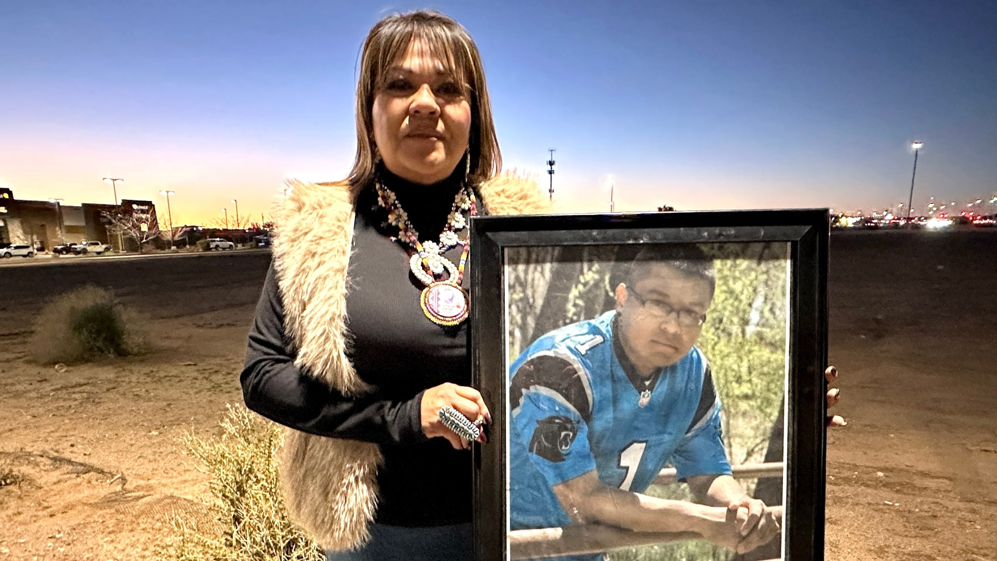 Vangie Randall-Shorty holds up a photograph of her son Zachariah Shorty during a stop in Bernalillo, N.M., Nov. 24, 2025. (AP Photo/Susan Montoya Bryan)