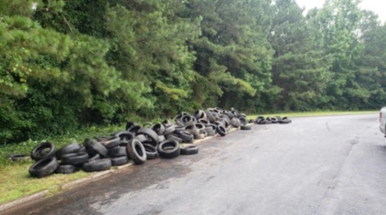 Lilburn officials, with the help of private property owners, cleaned up up more than 3,000 illegally dumped tires behind Lilburn Market Center. (Courtesy City of Lilburn)