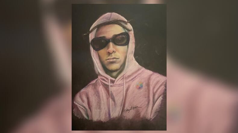 A GBI forensic artist drew a composite sketch of an armed robbery suspect who authorities said held up a package store in Gainesville on Feb. 28.