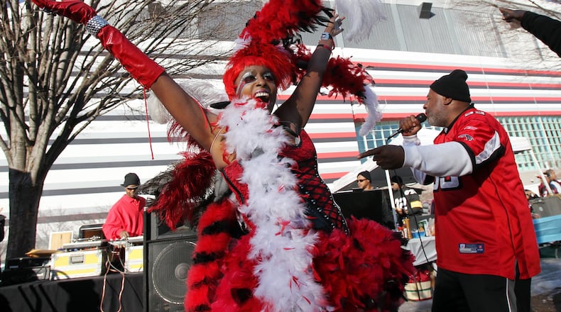 110115 Atlanta - Atlanta Falcons fan the "Bird Lady" Carolyn Freeman, Macon, and D.J. "Double L", Stone Mountain, fire up the crowd early outside the Georgia Dome before taking on the Green Bay Packers iin Atlanta on Saturday, Jan. 15, 2011. Curtis Compton ccompton@ajc.com