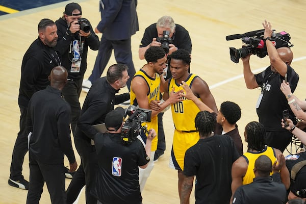 Indiana Pacers guard Bennedict Mathurin (00) and Indiana Pacers guard Tyrese Haliburton celebrate after Game 3 of the NBA Finals basketball series against the Oklahoma City Thunder, Wednesday, June 11, 2025, in Indianapolis. (AP Photo/Michael Conroy)